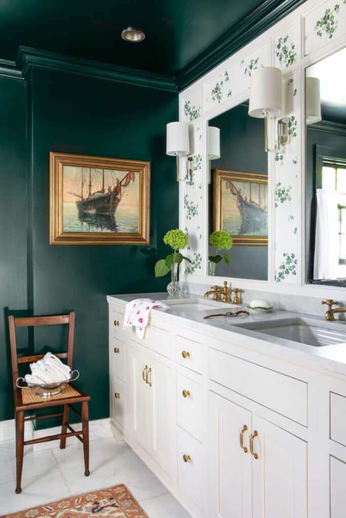 A bathroom with a dark forest green paint color on the walls.