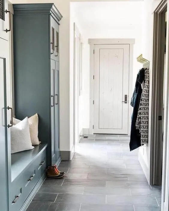 A mudroom with slate floors, White Dove on the walls and soft gray on the trim and door.