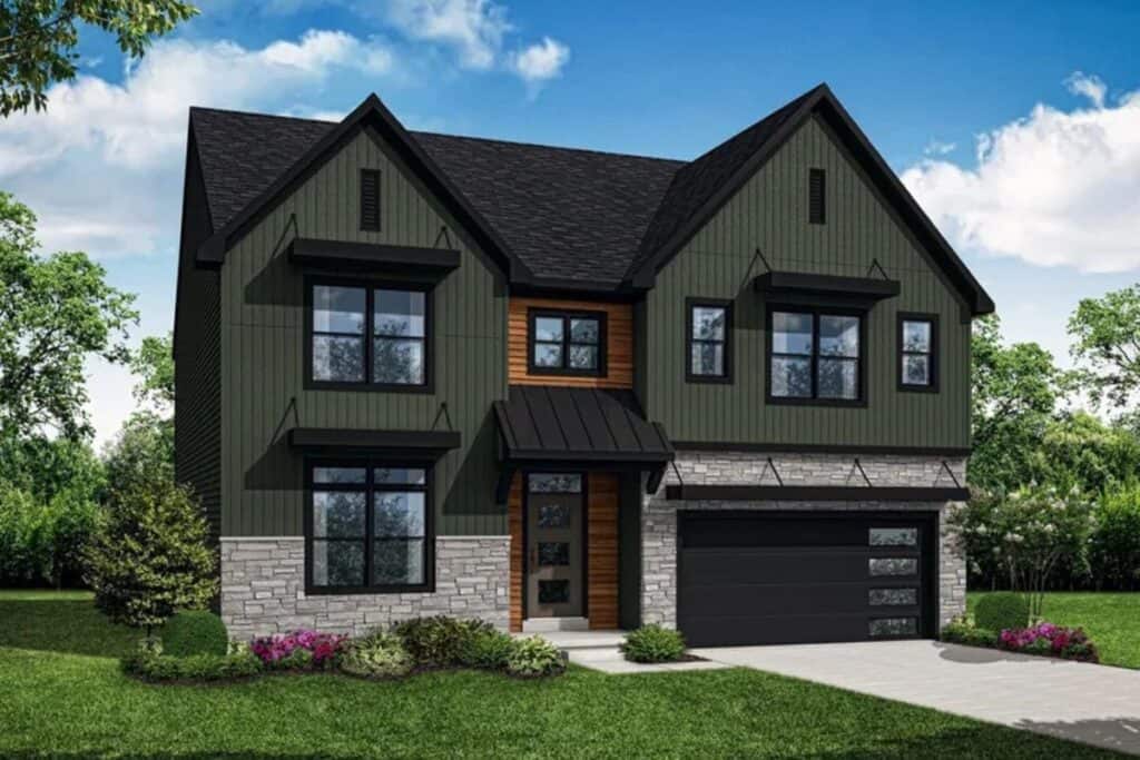 The exterior of a home painted dark green with black trim and awnings, stone skirting and wood around the front door and window above.