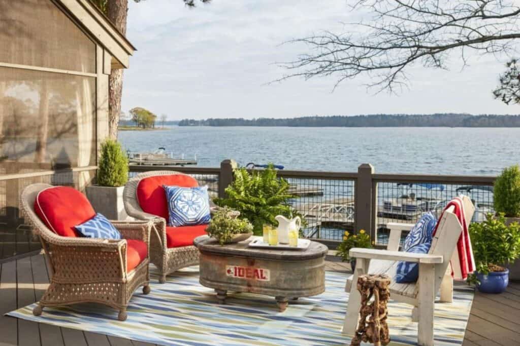 An outdoor space with seating in red white and blue and a view of the lake.