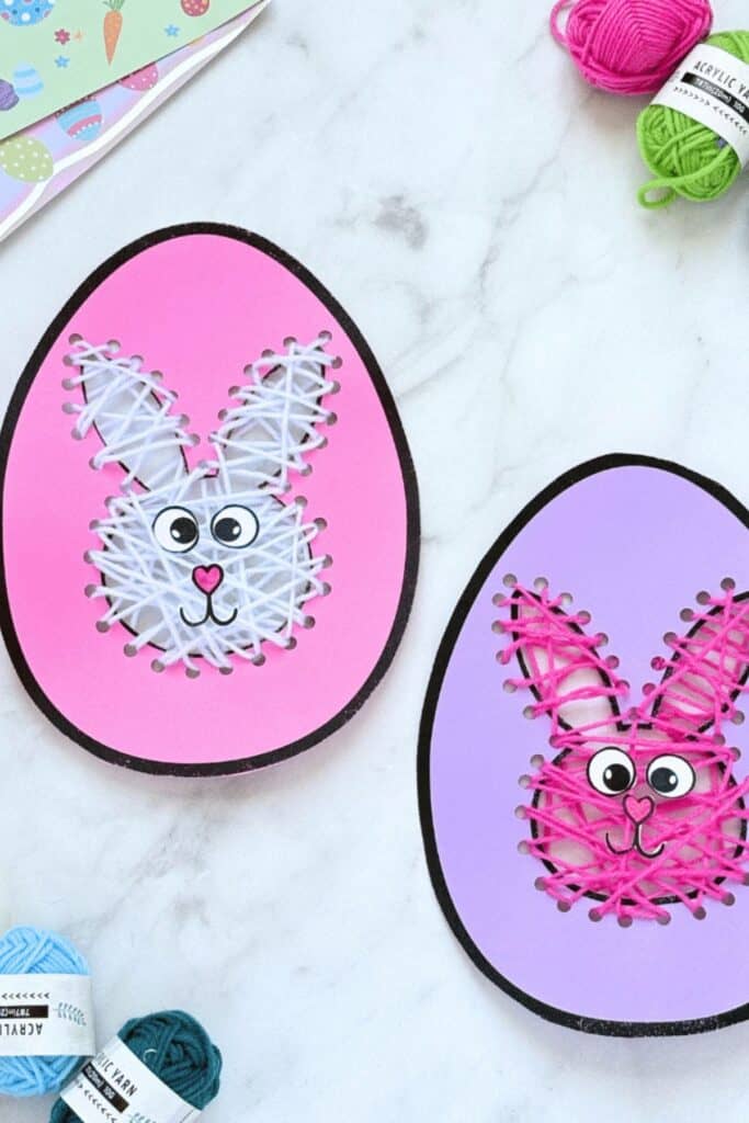 Eggs with cut outs of a bunny in the center and string laced through.