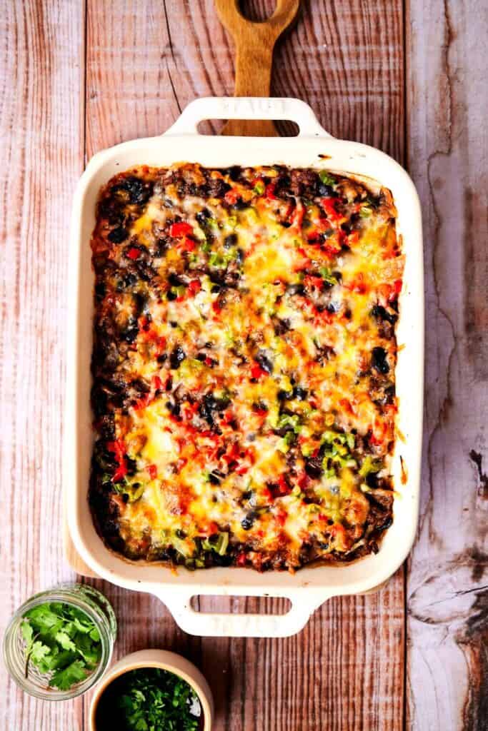 Burrito casserole ina. white 13X9 on a cutting board.