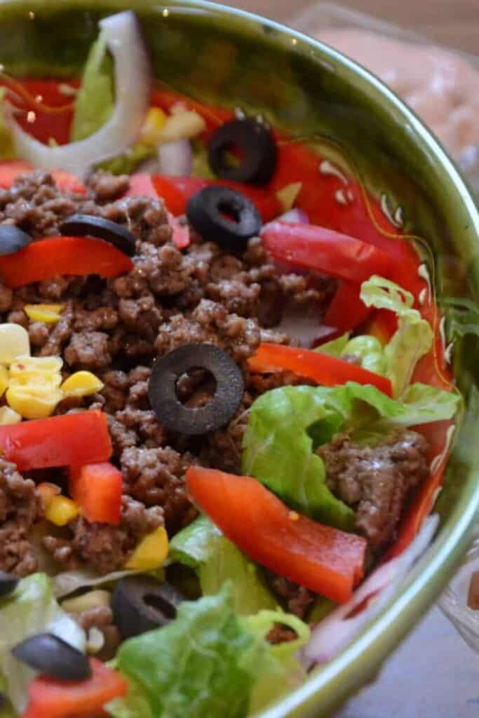 Fajita salad in a green bowl.