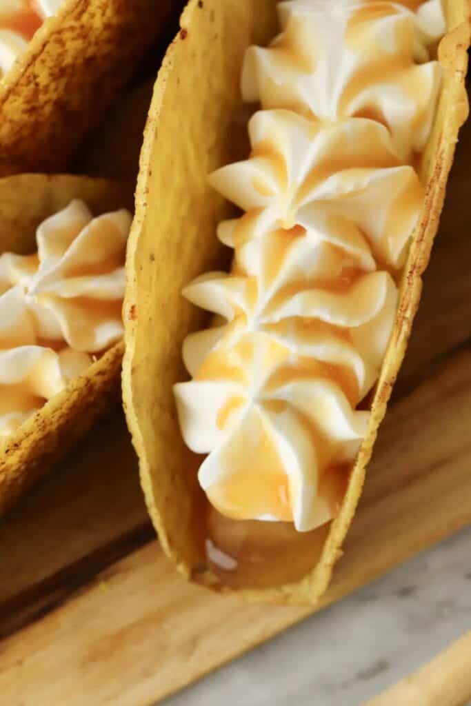 Apple pie dessert tacos on a cutting board.