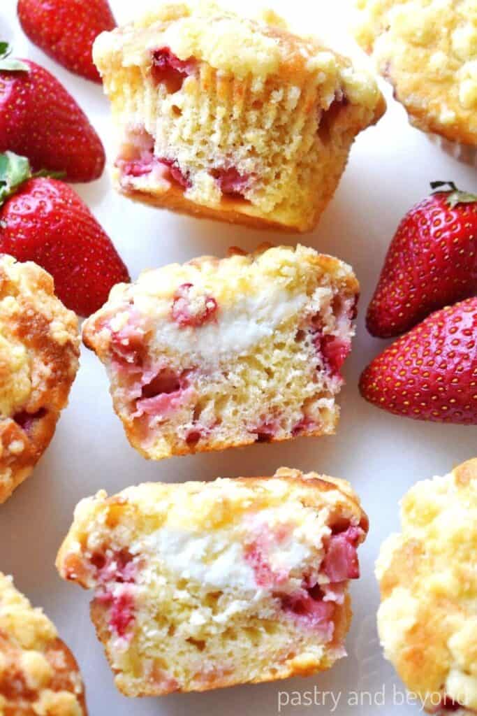 stawberry cream cheese muffins with strawberries on a white plate.