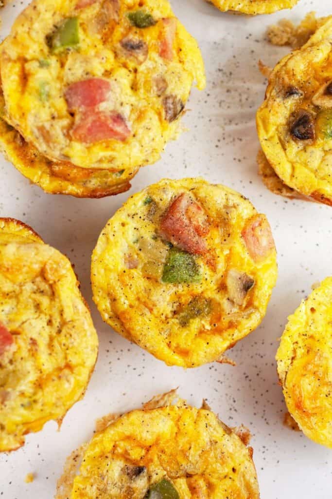 Omlette egg muffins on a speckled plate.