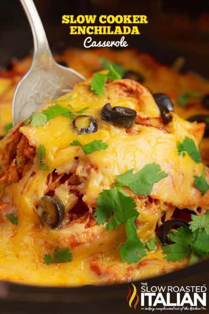 chicken enchilada casserole with cilantro and a silver spoon.